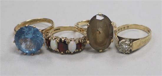 Four 9ct gold and gem set rings.